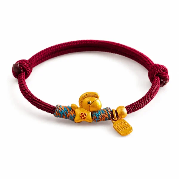 lucky charm bracelet red string gold horse on white background