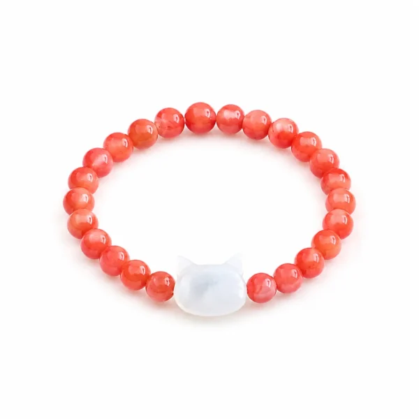 red beaded cat ring on white background
