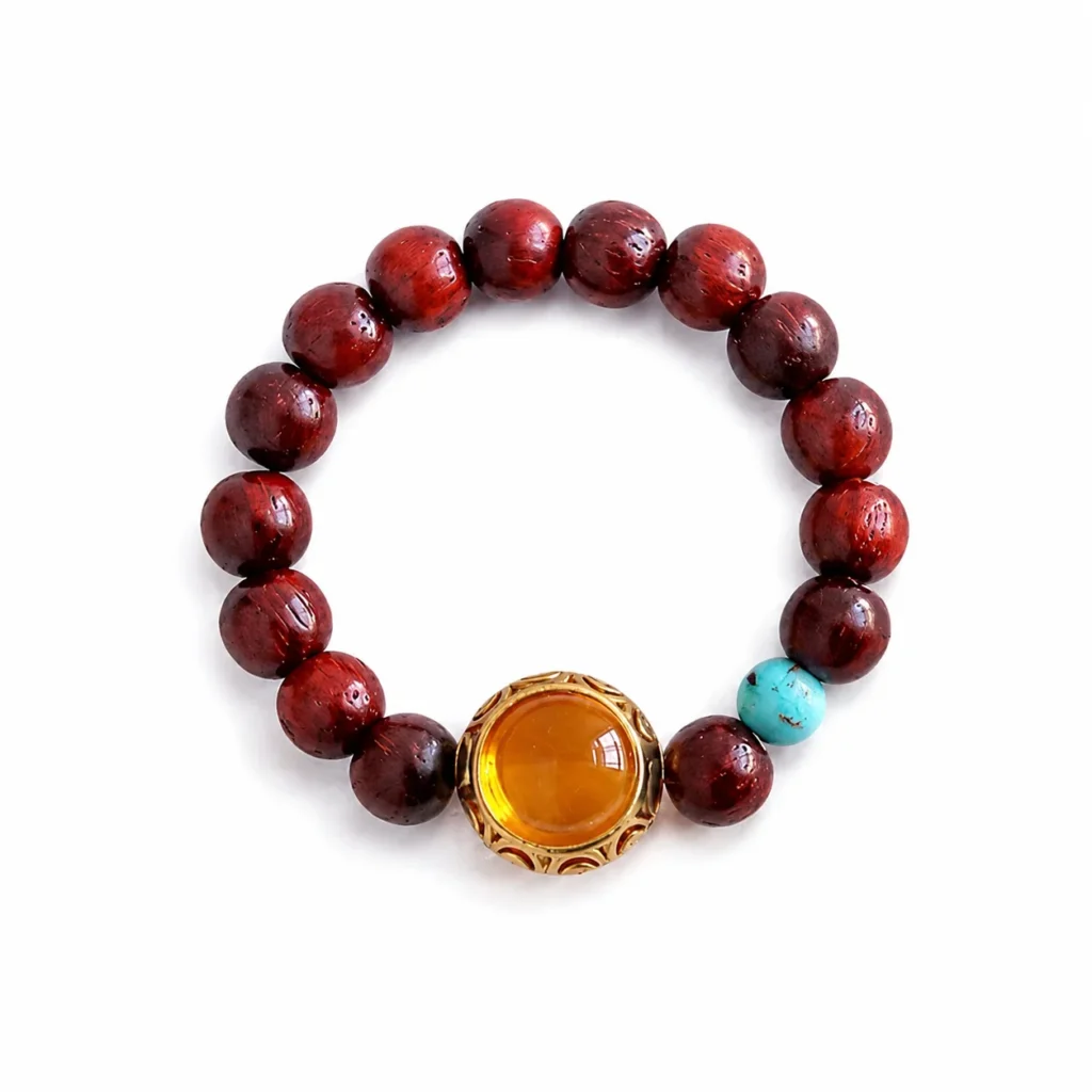 red sandalwood beaded ring amber center on white background