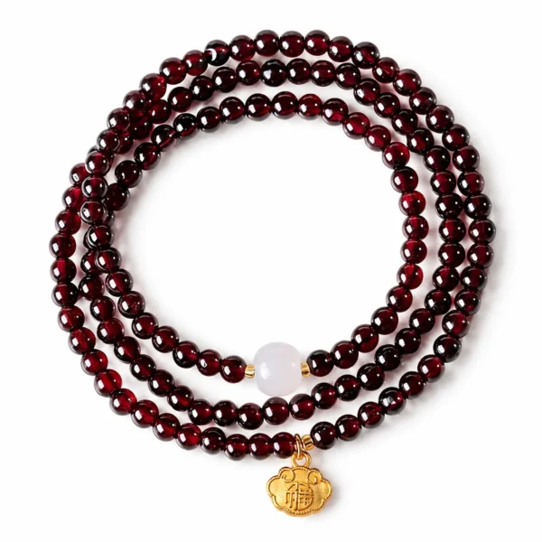 garnet white jade triple-wrap fu lock bracelet on white background