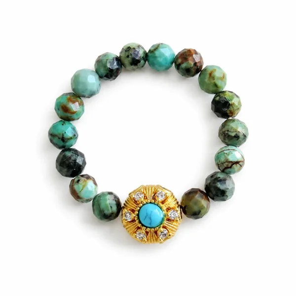 turquoise beaded ring on white background