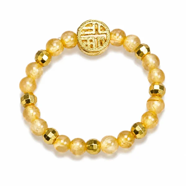 golden rutilated quartz fortune coin beaded ring on white background