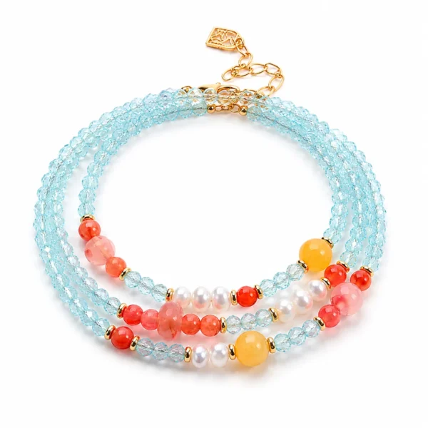 blue zircon pearl triple-wrap bracelet on white background