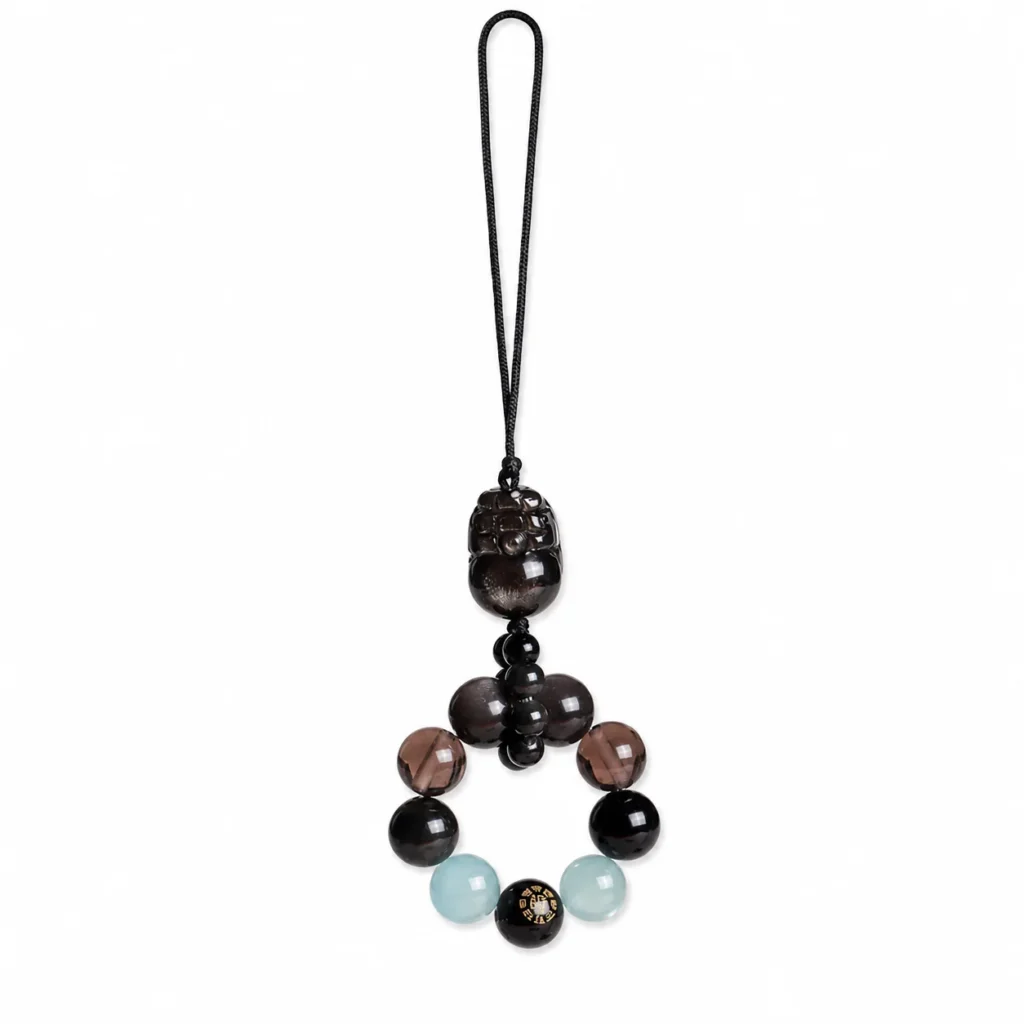 black obsidian pixiu agate phone charm on white background