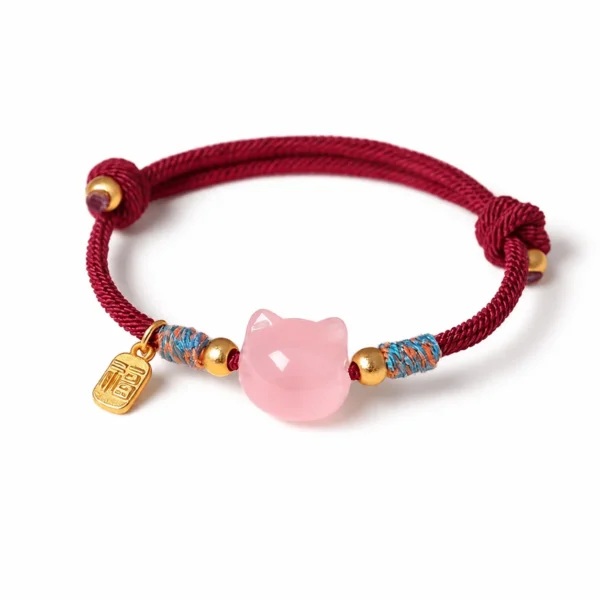 pink quartz cat lucky red string bracelet on white background